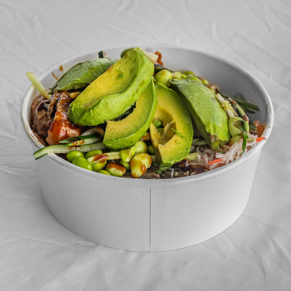 KOKOROLL Poke & Ramen bowl with avocado slices, edamame, and sauce, on a white background.