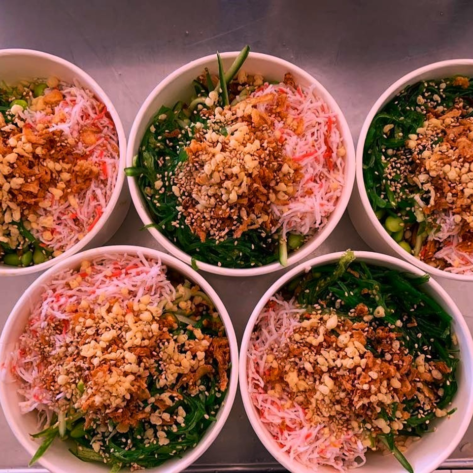 Five KOKOROLL poke bowls with crab, seaweed, edamame, and crispy toppings.
